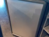 a refrigerator that is open on the counter in the kitchen