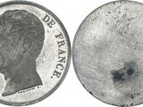 an old silver coin with a picture of a man ' s face on it