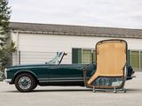 a green car with a wooden seat in front of a building