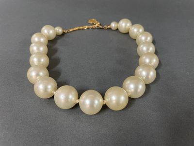 a close up of a white pearl necklace on a table