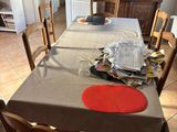 a dining room table with chairs and plates on it