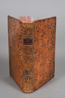 an old book sitting on top of a table next to a gray background