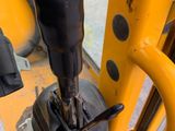 a close up of a yellow machine with a black knob