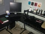 a computer desk with a laptop and a monitor on it
