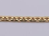 a gold bracelet with a chain on a white background