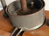 a small metal object that is on a wooden stand