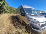 a silver van that is parked in the grass