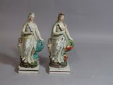 two figurines of a woman with a basket and a man with a bird