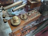 a glass table with a bunch of antique items on it