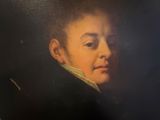 portrait of a young man in a black coat with a white collar