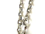 silver metal purse with chain on white background on white surface