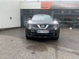 the front of a black nissan juke parked in front of a building