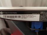 the back of a silver laptop with a barcode on it