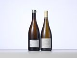 two bottles of wine sitting next to each other on a table
