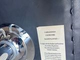 a close up of a black suitcase with a tag on it