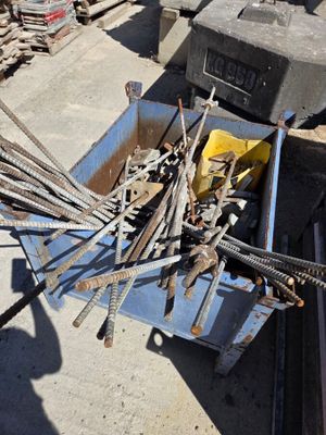 a pile of tools sitting on the ground next to a box