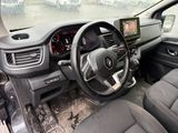 a picture of a car dashboard with a monitor and steering wheel