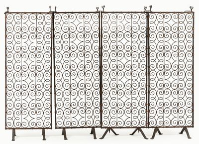 a group of four metal screens with scrolls and scrolls on them
