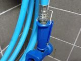 a blue hose attached to a blue hose in a bathroom