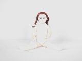 an image of a doll sitting on the ground with a white background