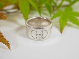 sterling silver ring with a dotted design on the outside of the ring