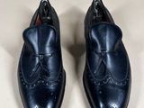 pair of blue leather shoes with a bow on the side