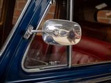 a reflection of a man in a mirror on the side of a car