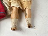 a doll that is laying on the floor next to a cloth