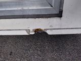 a crack in the side of a door that has been painted white