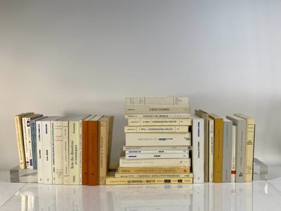 many books stacked on top of each other on a table