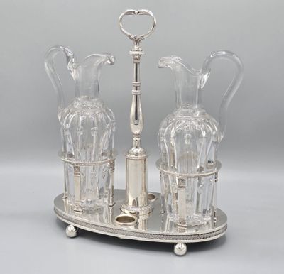 a silver plate with two glass vases on it