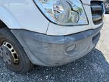 an image of a car with a denting front bumper