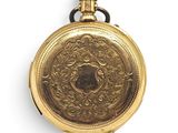 an old gold pocket watch with a chain on a white background