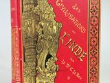 un livre rouge et doré dont la couverture est ornée d'un motif élaboré