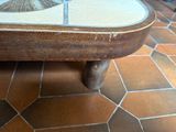 a coffee table with a fan on it on a tiled floor