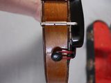 a person that is holding a violin in their hand