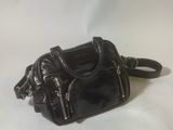 a small black purse on a white background