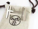 a small bag with a tie bar and a cross on it