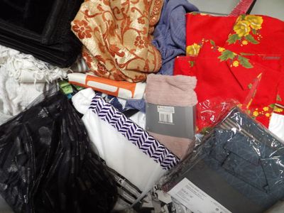 a pile of clothes and a purse on the floor