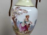 a vase with a picture of a woman and a child on it