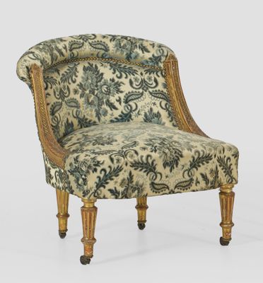 an upholstered chair with a floral upholstered back and legs
