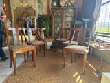 a room with a lot of chairs and a table in it