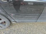 a black car that is parked on the side of the road