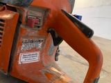 a chainsaw that is sitting on the ground