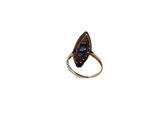 a close up of a ring with a blue stone in it