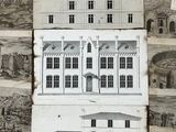 two drawings of a building on the wall