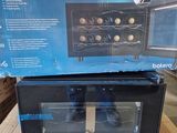 an image of a black microwave sitting on top of a cardboard box