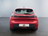 the rear end of a red car in a white room