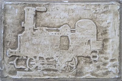 a stone plaque that has a train on it
