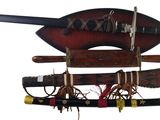 three different types of weapons hanging on a wall